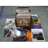 A large box of 12" vinyl records to include The beach Boys, Howard Jones, a-ha, Meat Loaf,