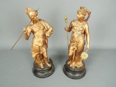 A pair of metal sculpture depicting figures in classical dress, approximately 35 cm (h).