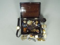A Japanese lacquered box containing costume jewellery, wrist watches,