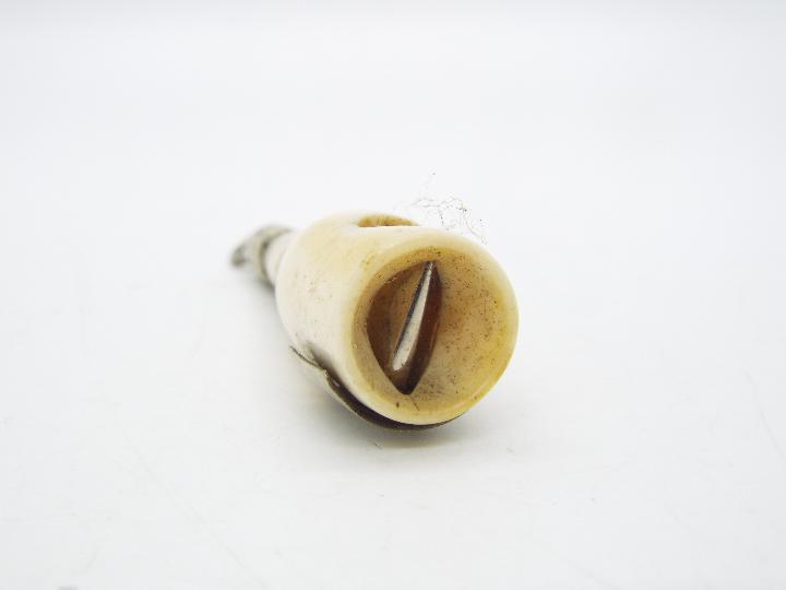 A late Victorian ivory and white metal novelty cigar cutter in the form of a champagne bottle, - Image 3 of 4