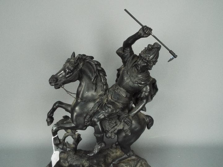 A cast metal sculpture depicting a warrior on horseback, approximately 53 cm (h). - Image 2 of 4