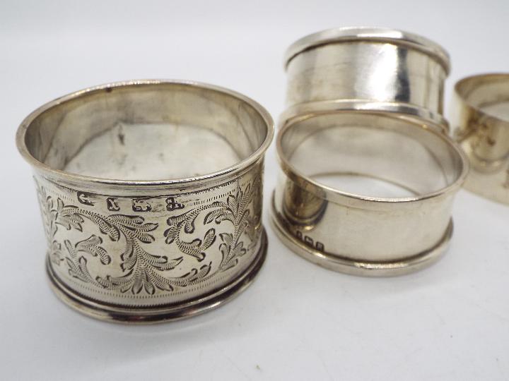 Five hallmarked silver napkin rings, varying assay and date marks, approximately 98 grams / 3. - Image 2 of 3