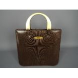 A vintage Mulberry handbag with gold tone arch handles, lined with single zip internal pocket,