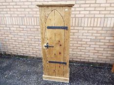 A good quality pine cupboard having single lancet top door, approximately 153 cm x 61 cm x 38 cm.