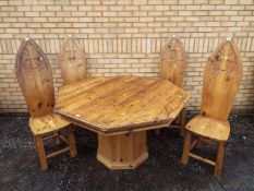 An octagonal topped dining table with metal mounts,