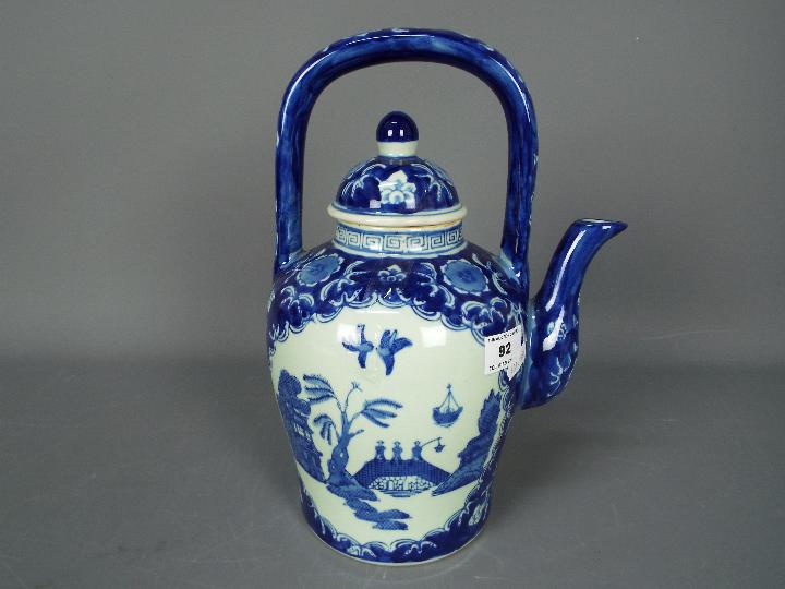 A large blue and white teapot decorated