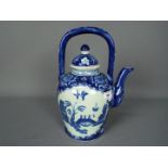 A large blue and white teapot decorated