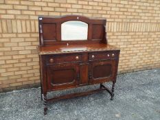 An oak sideboard with mirror back, appro