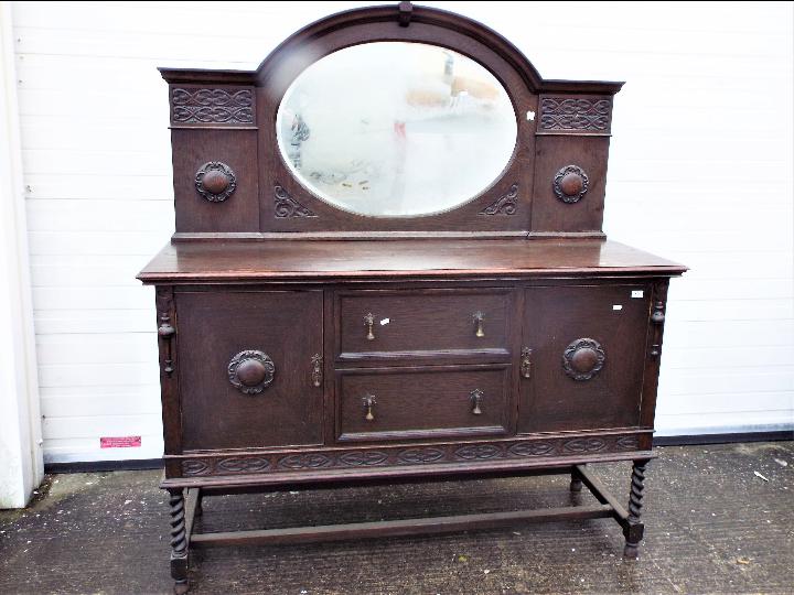 A mirror back, oak sideboard with carved