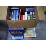 A collection of boxed jigsaw puzzles.