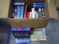 A collection of boxed jigsaw puzzles.