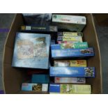 A collection of boxed jigsaw puzzles.