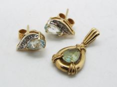 A 9ct gold stone set pendant and a pair of stone set earrings, approximately 2.6 grams all in.