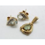 A 9ct gold stone set pendant and a pair of stone set earrings, approximately 2.6 grams all in.