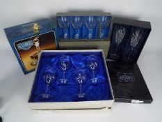 A quantity of boxed crystal glassware.