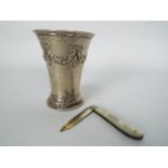 A small Swedish silver vase with repousse decoration, 1904, approximately 9 cm (h) and 66 grams / 2.