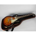 An Epiphone Les Paul Standard electric guitar, Vintage Sunburst, contained in carry case.