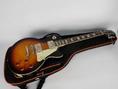 An Epiphone Les Paul Standard electric guitar, Vintage Sunburst, contained in carry case.