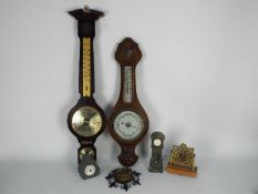 Two banjo barometers and a collection of small clocks.