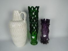 Two art glass vases to include one of reticulated form and a large white glazed ceramic ewer,