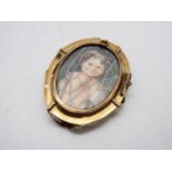 A yellow metal photograph brooch / pendant (pin lacking), approximately 5.5 cm x 4.3 cm and 20.