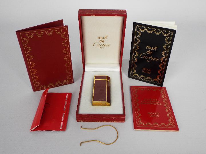 A Must de Cartier Briquet cigarette lighter contained in original box with paperwork.