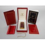 A Must de Cartier Briquet cigarette lighter contained in original box with paperwork.