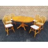 An extending kitchen table and six chairs,