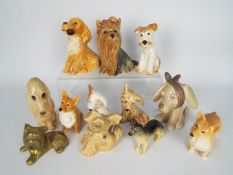 A collection of dog figurines, Beswick and Sylvac, largest approximately 14 cm (h),