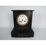 A French black slate mantel clock with incised gilt highlights, Roman numerals to a 4" enamel dial,