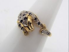 A 9ct gold sapphire and diamond, Cartier style ring in the form of a panther, size O½,