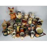 A good collection of novelty teapots, character jugs and Toby jugs, two boxes.