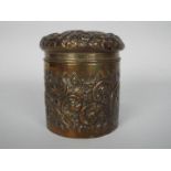 An Edward VII silver powder box with floral and foliate repousse decoration, Birmingham assay 1903,