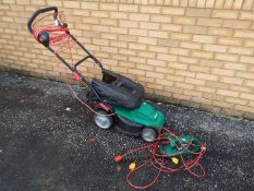 A Qualcast 1400w Electric Rotary Lawnmower and a Hedge Master hedge trimmer.