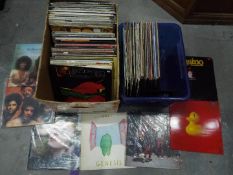 Two boxes of 12" vinyl records to include Jazz, David Bowie, Sad Cafe, Genesis and similar.