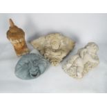 A collection of reconstituted stone garden ornaments to include wall pocket, recumbent putto,