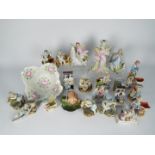 A collection of German porcelain figurines and similar to include centrepiece, fairings,