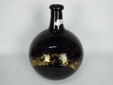 A 19th century, amethyst glass, apothecary carboy / demijohn of bulbous form,