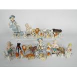 A group of miniature porcelain figures to include Ernst Bohne & Sohne putti, animals and similar.