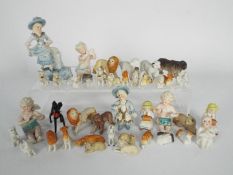 A group of miniature porcelain figures to include Ernst Bohne & Sohne putti, animals and similar.