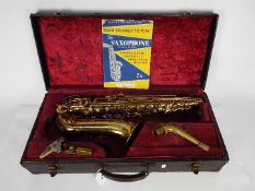 A vintage Triebert alto saxophone, cased.