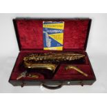 A vintage Triebert alto saxophone, cased.