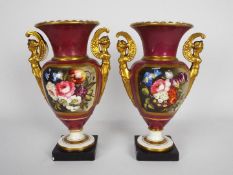 A pair of Vienna style porcelain, twin handled urns each decorated with floral panels,