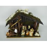 A Christmas Nativity diorama with ceramic figures,