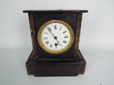 A French black slate and marble mantel clock with Roman numerals to a 3½" enamel dial,