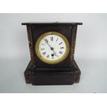 A French black slate and marble mantel clock with Roman numerals to a 3½" enamel dial,