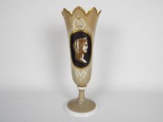 A late 19th century glass vase decorated with a classical figure in profile with Greek key border,