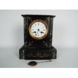 A French black slate and green marble mantel clock with 4" enamel dial having Roman numerals,