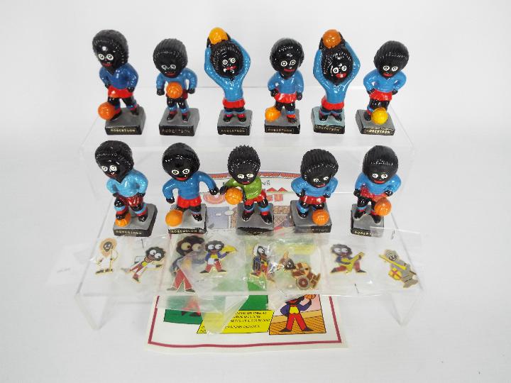 A quantity of Robertsons Golly figurines, footballers and seven enamel badges to include viking,