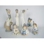 Seven Spanish porcelain figurines by Nao, largest approximately 24 cm (h).